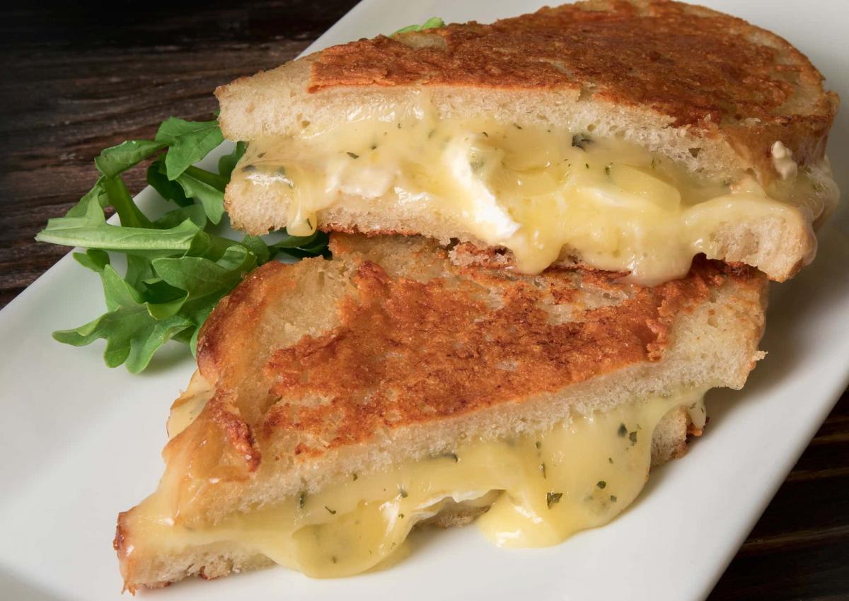 Grilled cheese sandwich plated with arugula